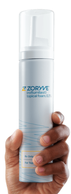 Hand holding ZORYVE topical foam canister